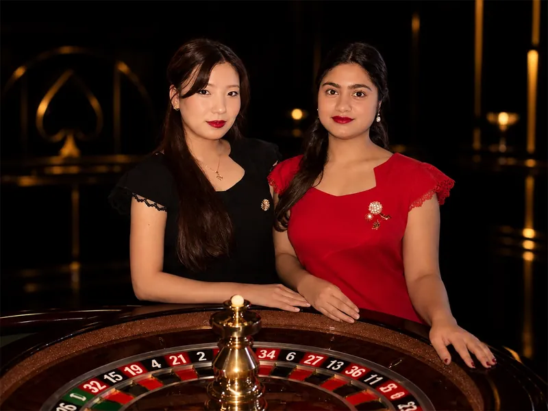 Two NeoBet presenters at a live roulette wheel in the Tbilisi studio.